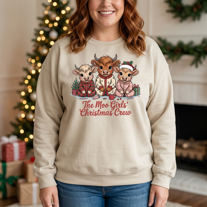 Woman modeling The Moo Girls’ Christmas Crew sweatshirt in Sand in a Christmas decorated home