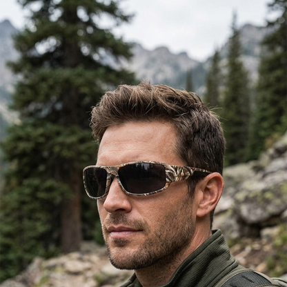 Male model wearing Grey Shadow Creek camouflage sunglasses on an outdoor trail.