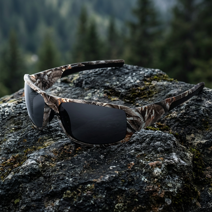 Grey lens Shadow Creek camouflage sunglasses in an outdoor mountain woodland setting.